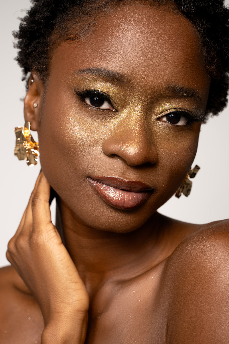 Beauty portrait with gold makeup